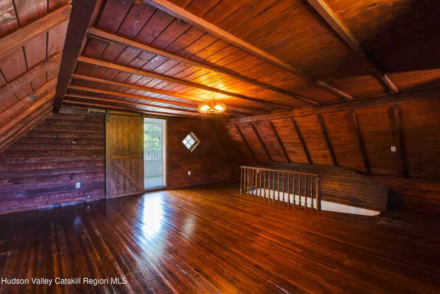 a view of a big house with a big yard and large trees