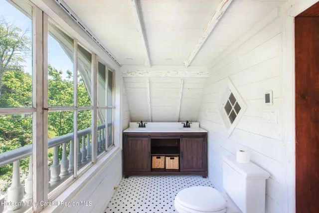 a view of staircase with furniture and wooden floor