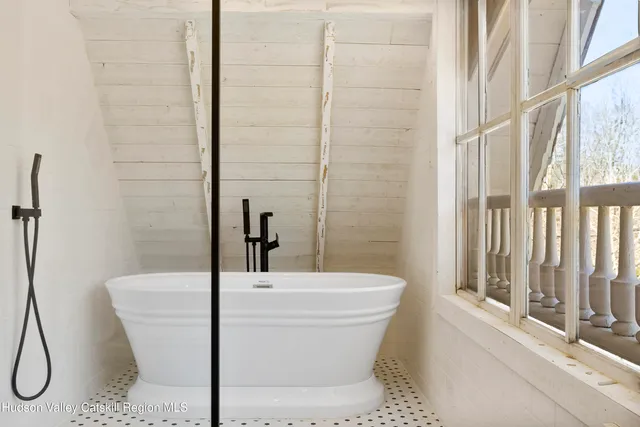 a view of a big house with a big yard and large trees