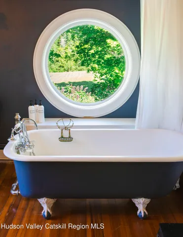 an aerial view of a house with a yard and lake view