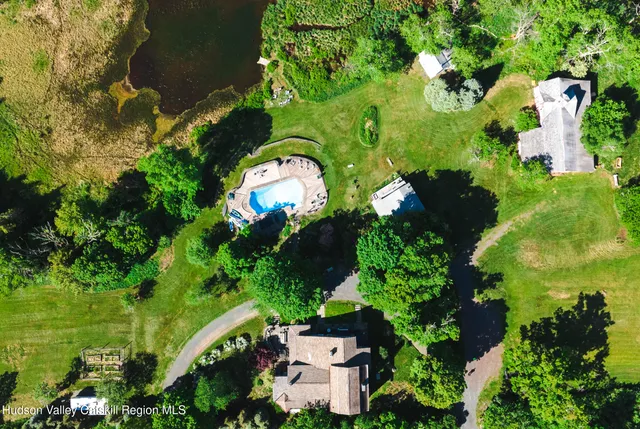 a view of a lake with a yard and a patio