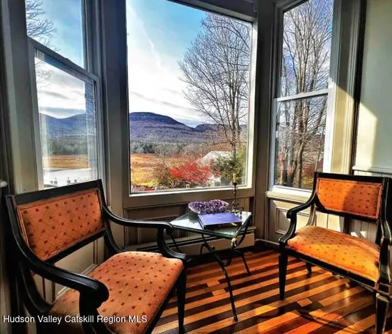 a living room with furniture chandelier and a window