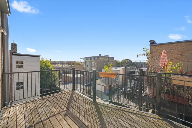 a view of a balcony with wooden floor