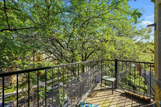 a view of a balcony with wooden floor