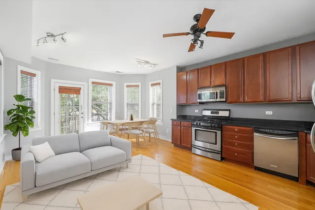 a living room with furniture kitchen and a stove