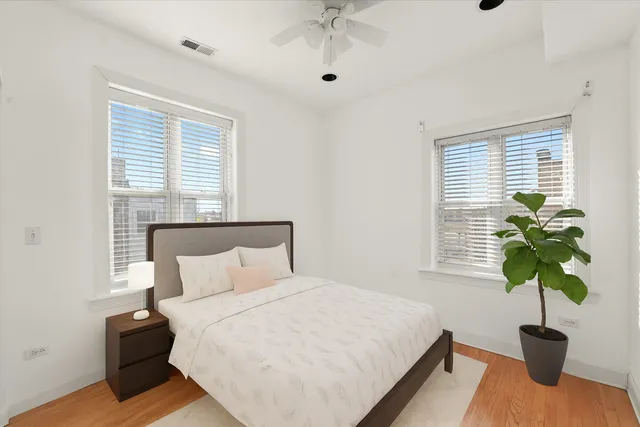 a bedroom with a bed potted plant with the window