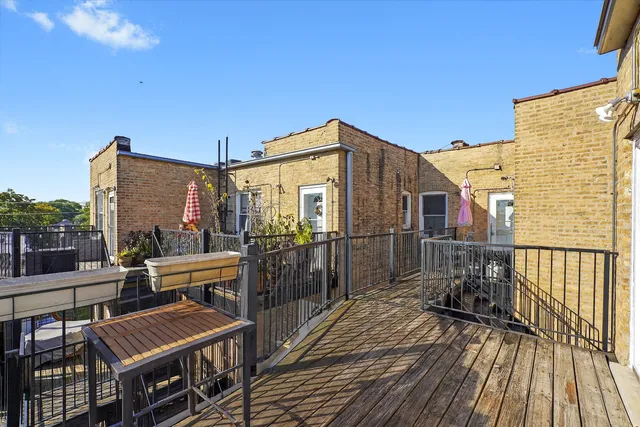 a view of a balcony with chairs and wooden floor