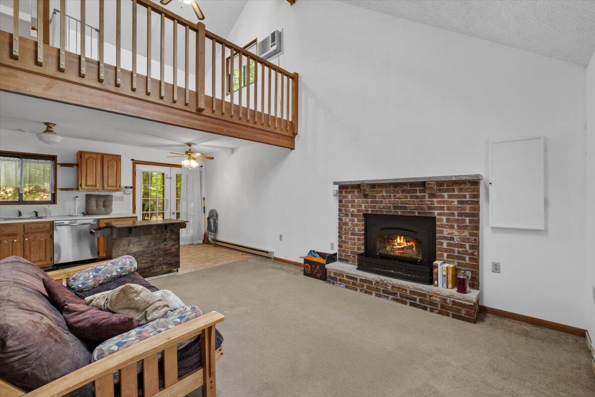 117 Manchester Drive Bushkill, PA 18324 - Photo 12 of 33 a living room with furniture a flat screen tv and a fireplace