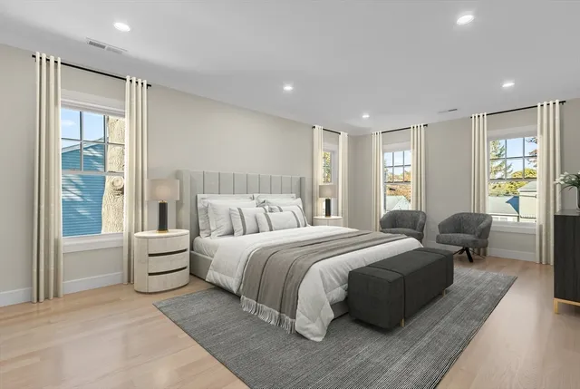 a spacious bedroom with a large bed and a couch