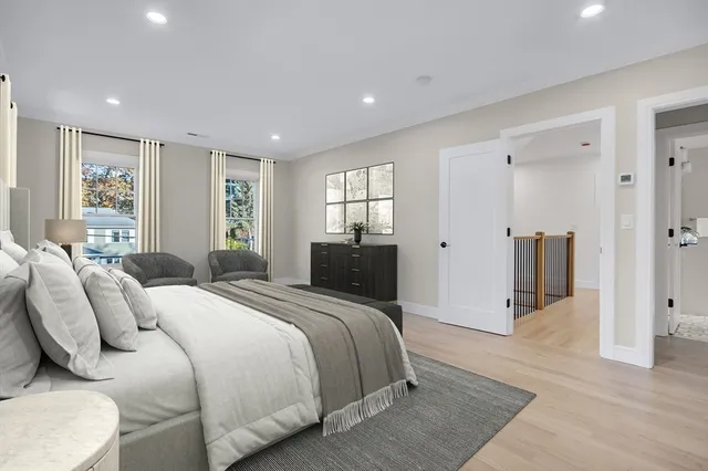 a bedroom with a bed and a large mirror