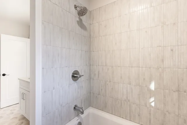 a bathroom with a bathtub and shower
