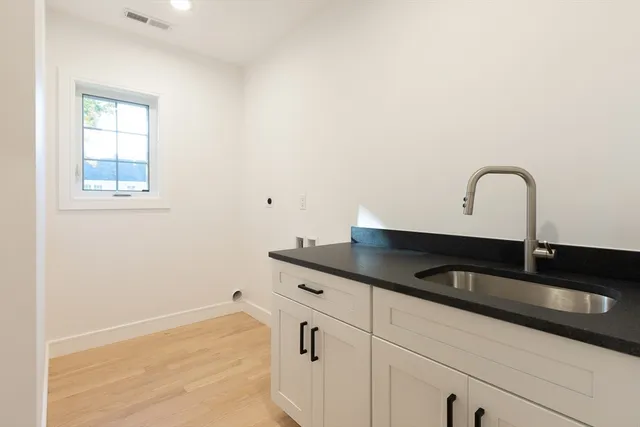 a close view of a sink and dishwasher with kitchen island