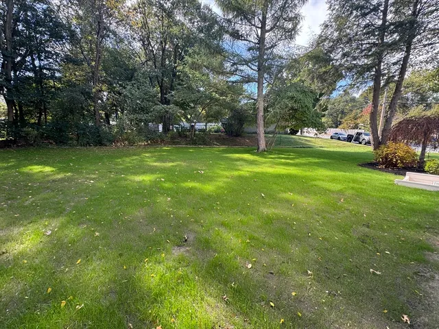 a picture of a bathroom with a window and a white cabinet
