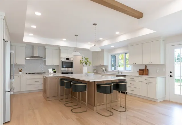 a kitchen with kitchen island cabinets and chairs in it