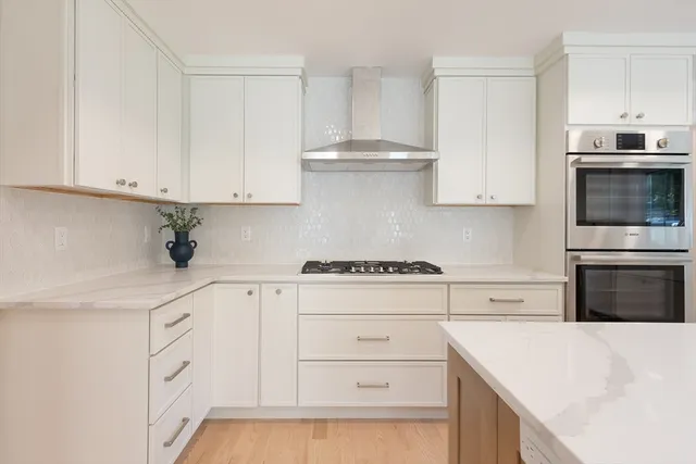 a kitchen with cabinets appliances a sink and a counter top