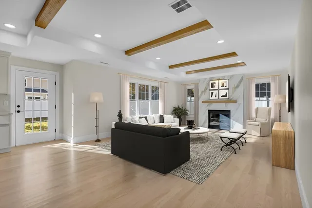 a living room with furniture a fireplace and a table