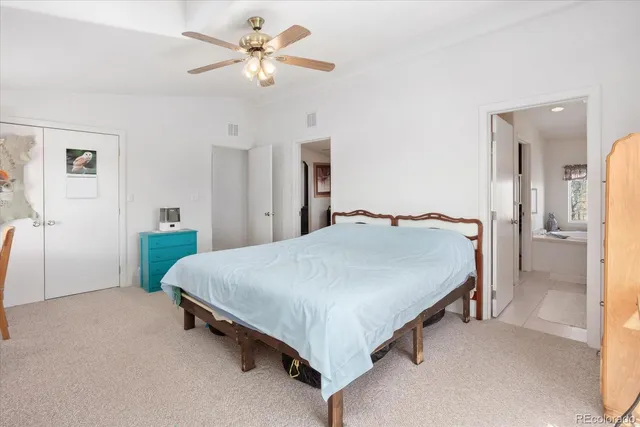 a bathroom with a granite countertop sink a toilet a large mirror and shower