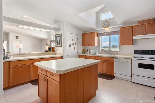 a kitchen with stainless steel appliances granite countertop a sink and a refrigerator
