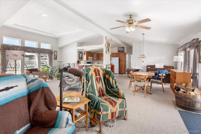 a view of a livingroom with workspace and a window