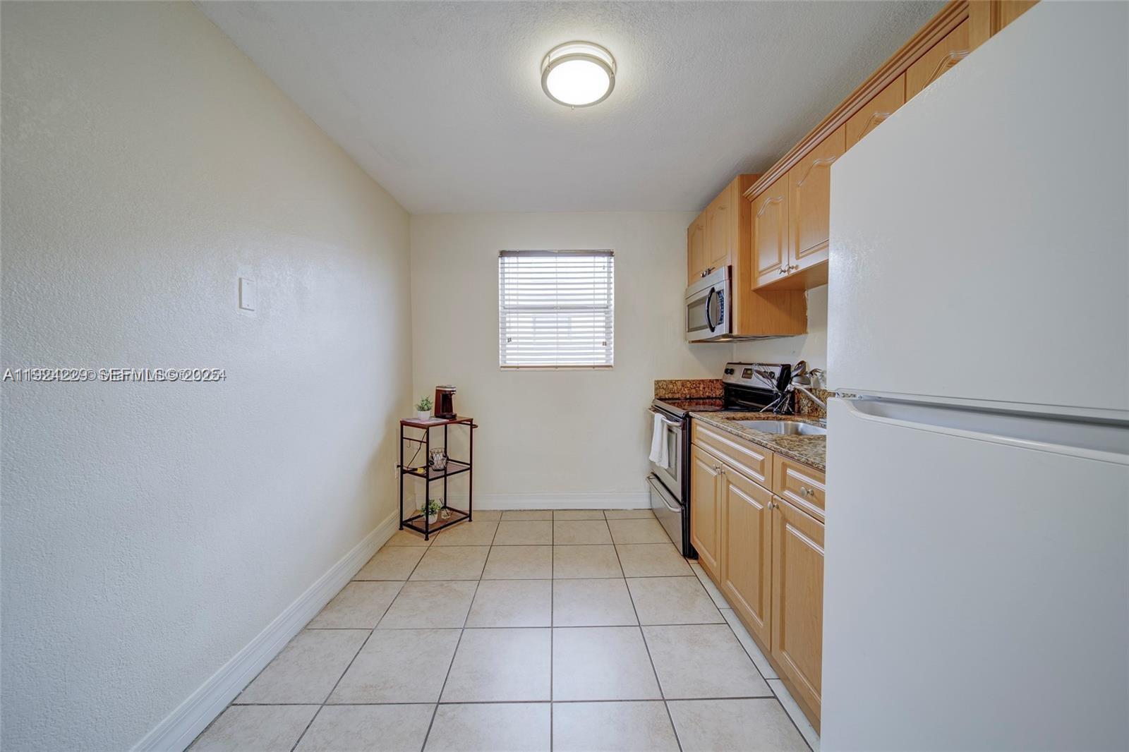 427 Southwest 6th Street, Unit 4 Miami, FL 33130 - Photo 2 of 13 a kitchen with cabinets and appliances