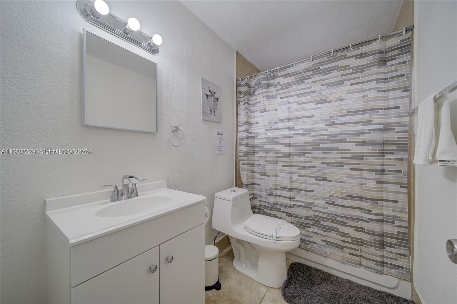 427 Southwest 6th Street, Unit 4 Miami, FL 33130 - Photo 7 of 13 a bathroom with a sink a toilet and mirror