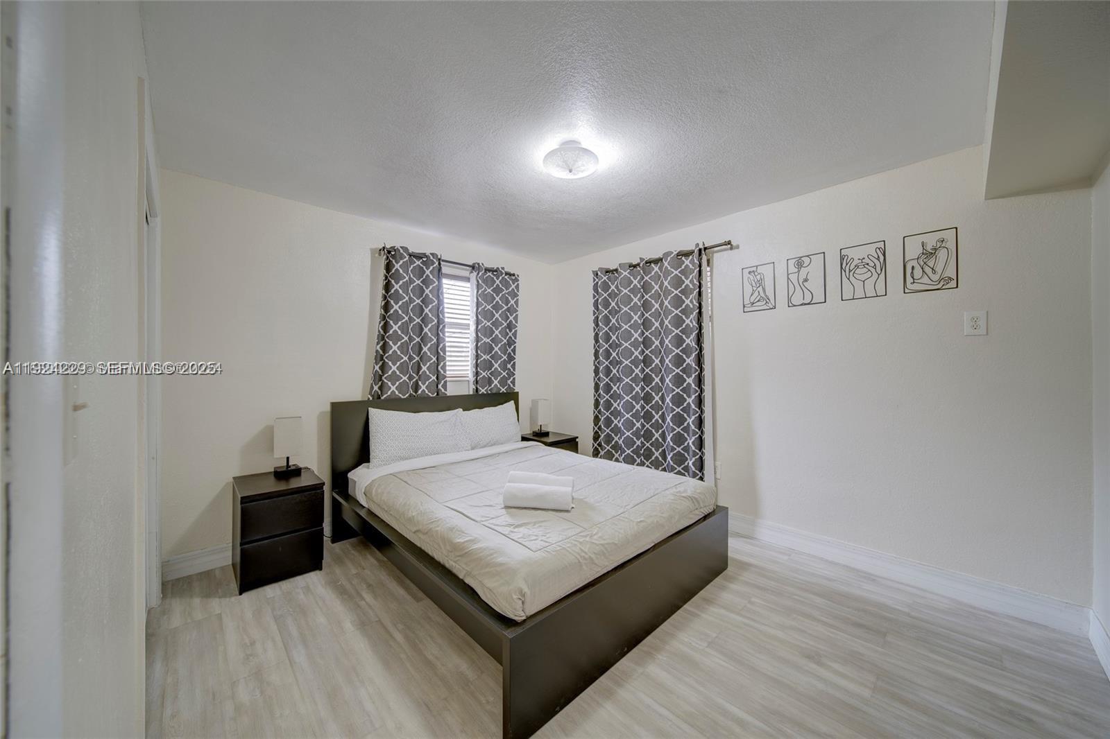 427 Southwest 6th Street, Unit 4 Miami, FL 33130 - Photo 8 of 13 a bedroom with a bed and a walk in closet