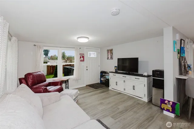 a bedroom with furniture and a flat screen tv