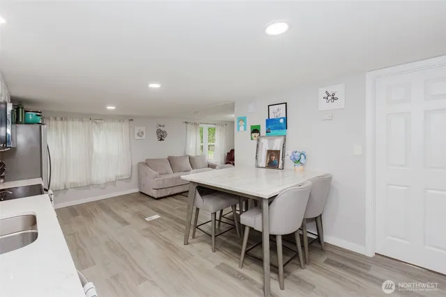 a view of a dining room with furniture and wooden floor
