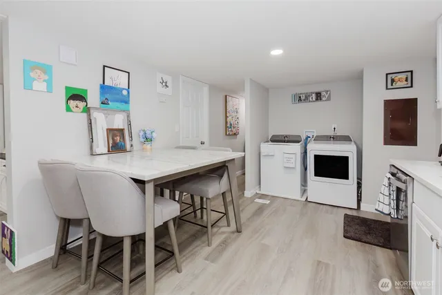 a kitchen with a dining table chairs and a refrigerator