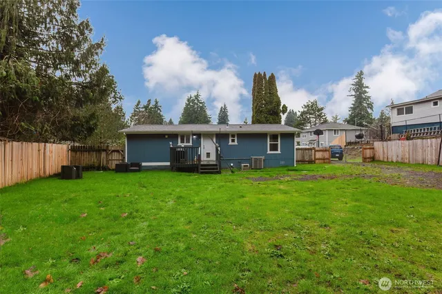 a view of a house with backyard and a sitting area