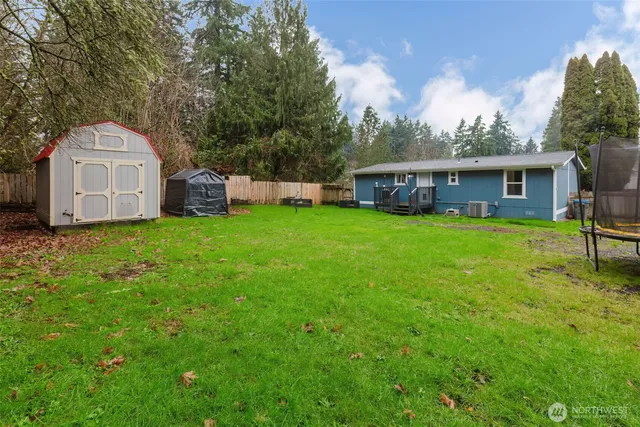 a view of a house with a yard and sitting area