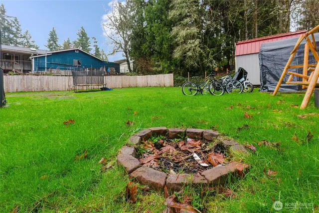a view of a house with a backyard and a patio