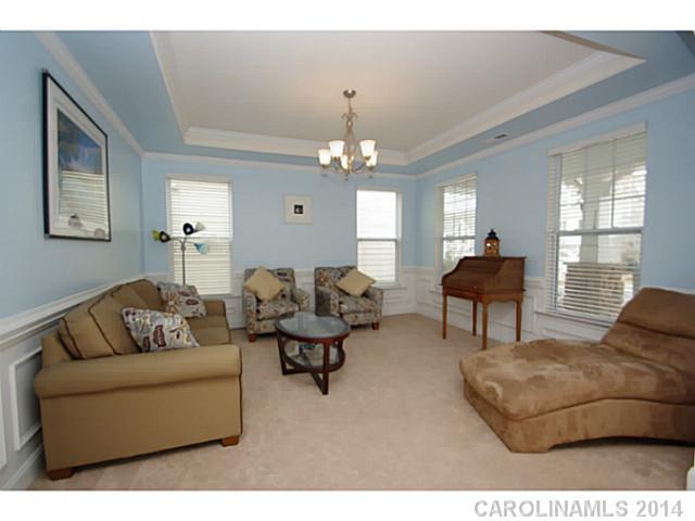2005 Fallondale Road, Unit 921 Waxhaw, NC 28173 - Photo 3 of 16 a living room with furniture and a chandelier
