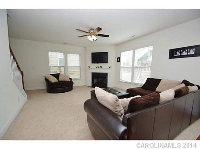 2005 Fallondale Road, Unit 921 Waxhaw, NC 28173 - Photo 6 of 16 a living room with furniture fireplace and a flat screen tv