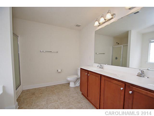 2005 Fallondale Road, Unit 921 Waxhaw, NC 28173 - Photo 8 of 16 a bathroom with a sink vanity granite and toilet