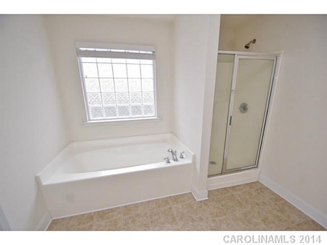 2005 Fallondale Road, Unit 921 Waxhaw, NC 28173 - Photo 9 of 16 a bathroom with a bathtub and a shower