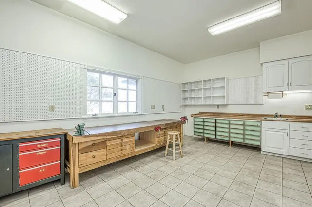 an aerial view of residential houses with outdoor space and swimming pool