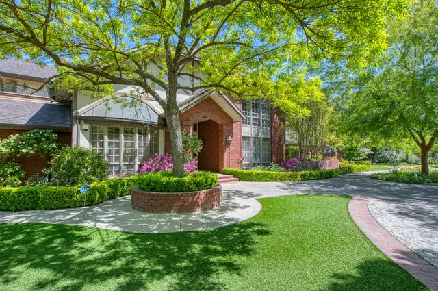 a view of a livingroom with wooden floor and a large window