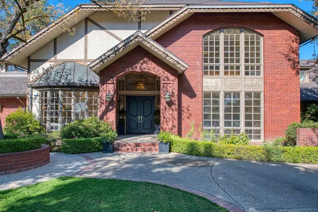 a view of an empty room with a fireplace and a window