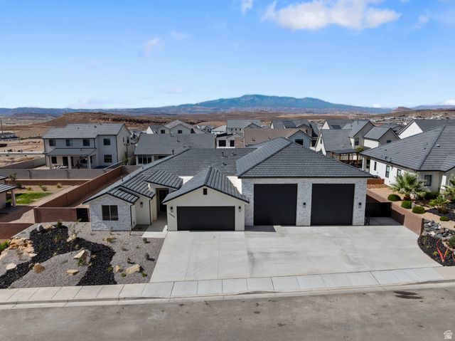2955 East Rimrunner Drive St. George, UT 84790 - Photo 33 of 35 Contemporary single-story residence with a multi-car garage, concrete driveway, and textured roof