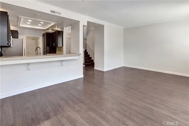 a view of a room with wooden floor and fireplace