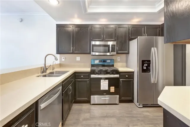 a kitchen with stainless steel appliances a sink and stove