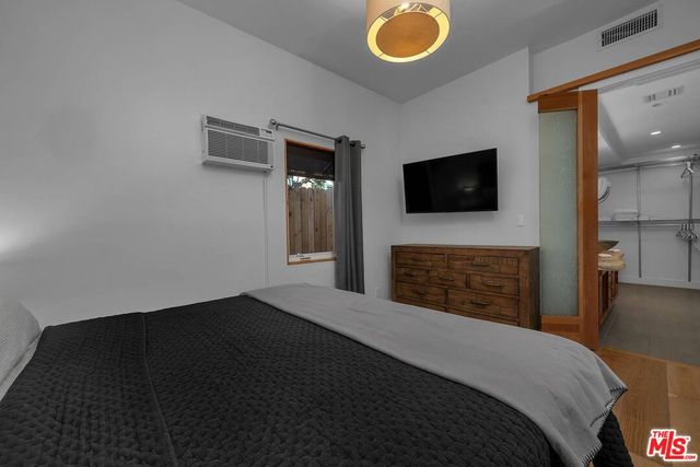 a bedroom with a bed and cabinets