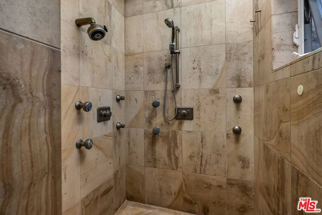 a bedroom with a bed and a mirror