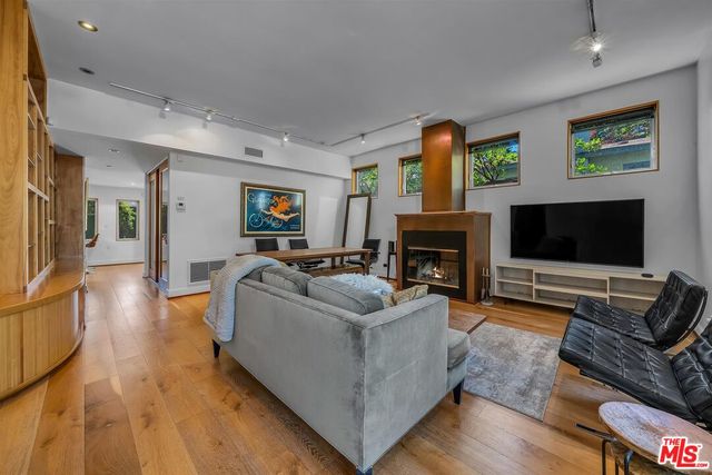 a living room with furniture flat screen tv and a fireplace