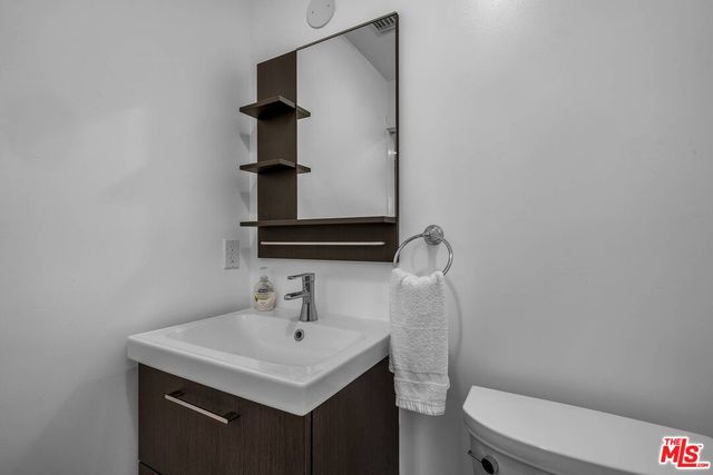 a view of a bedroom with wooden floor