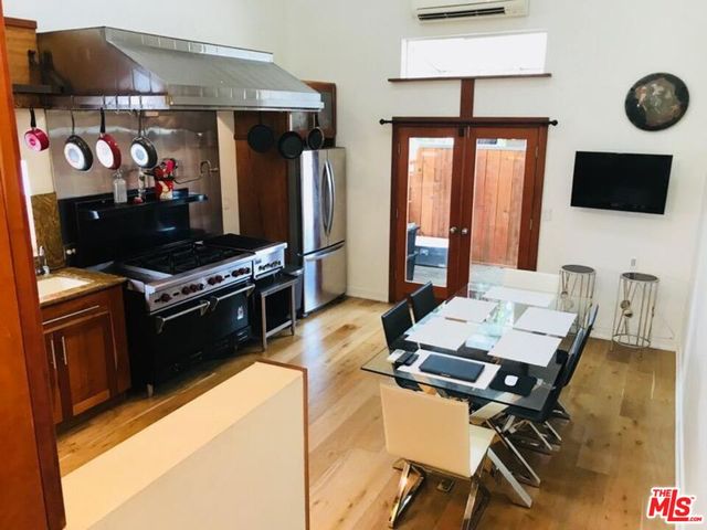 a view of a dining room with furniture and a potted plant