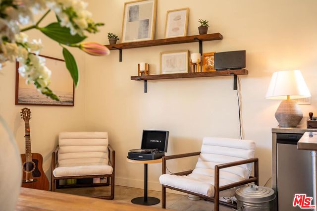 a living room with furniture a rug and a bookshelf