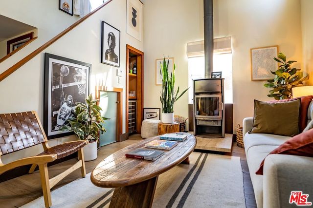 a bedroom with a large bed and a potted plant