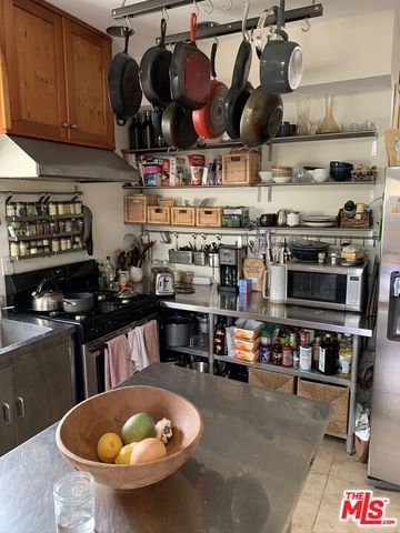 a view of a patio with table and chairs potted plants with wooden floor and fence